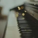 selective focus photography of black wooden piano keys