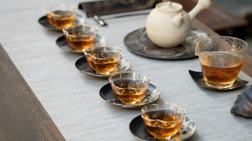 clear drinking glass with liquid on gray surface