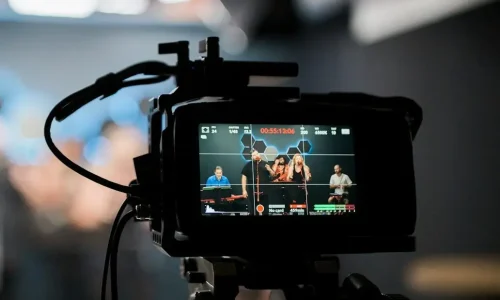 black dslr camera taking photo of city lights