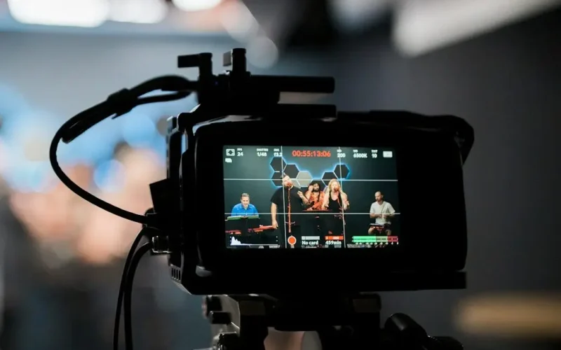 black dslr camera taking photo of city lights