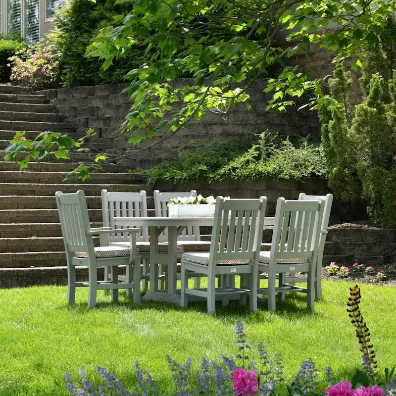 white wooden dining table with chairs set on grass